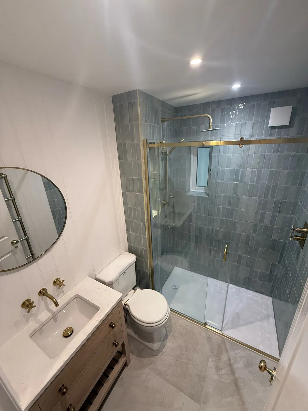 Completed bathroom in Hammersmith with walk-in shower, extractor fan and lighting by New-Gen Sparks