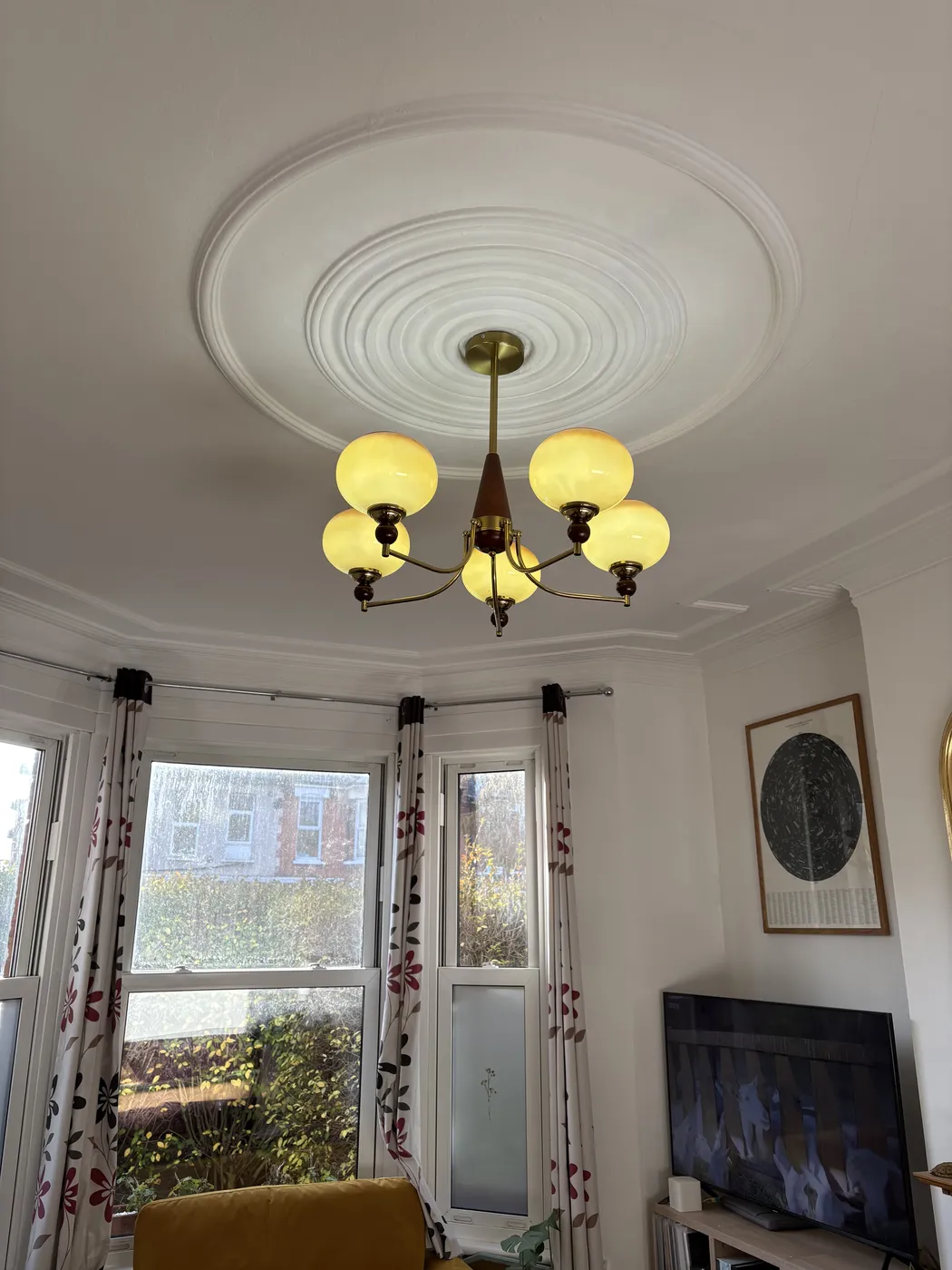 Five-arm brass chandelier installed on a period ceiling rose in Kensington