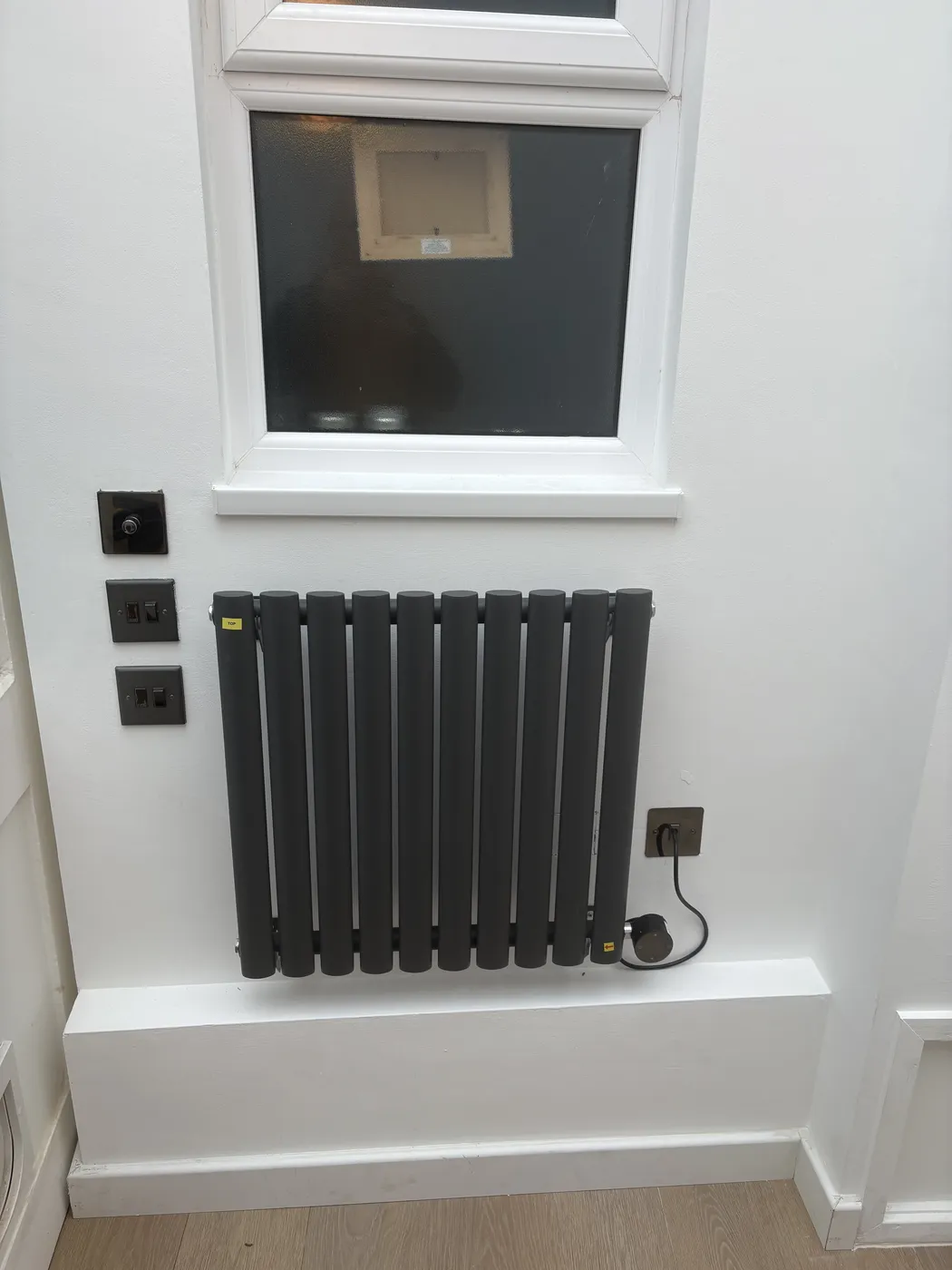 Wall-mounted electric radiator wired to a new fused spur in W2