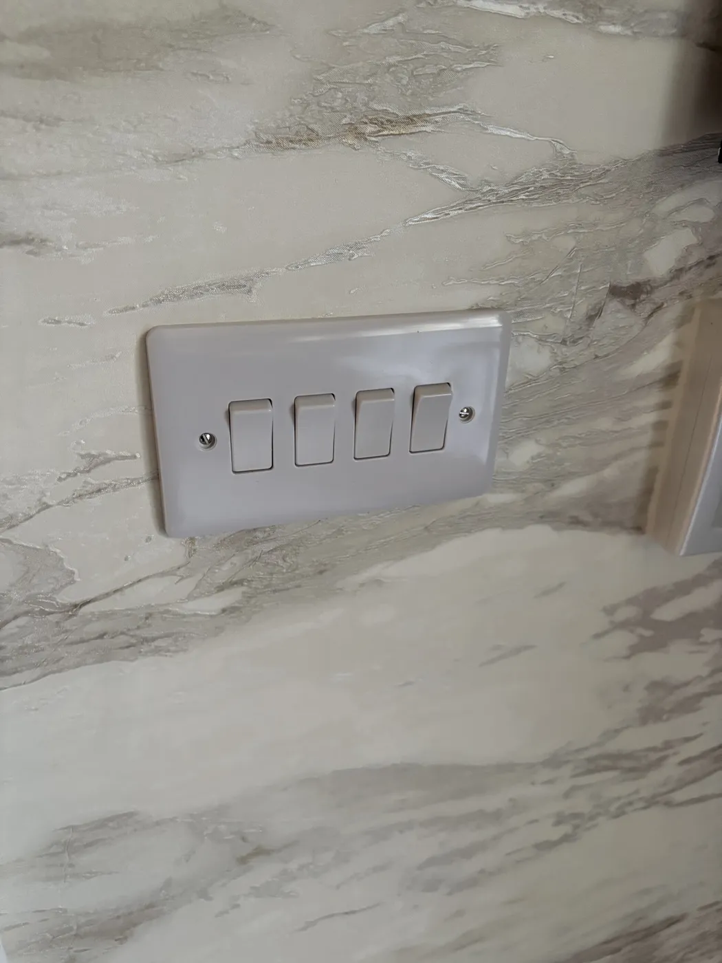Four-gang light switch neatly installed in Maida Vale