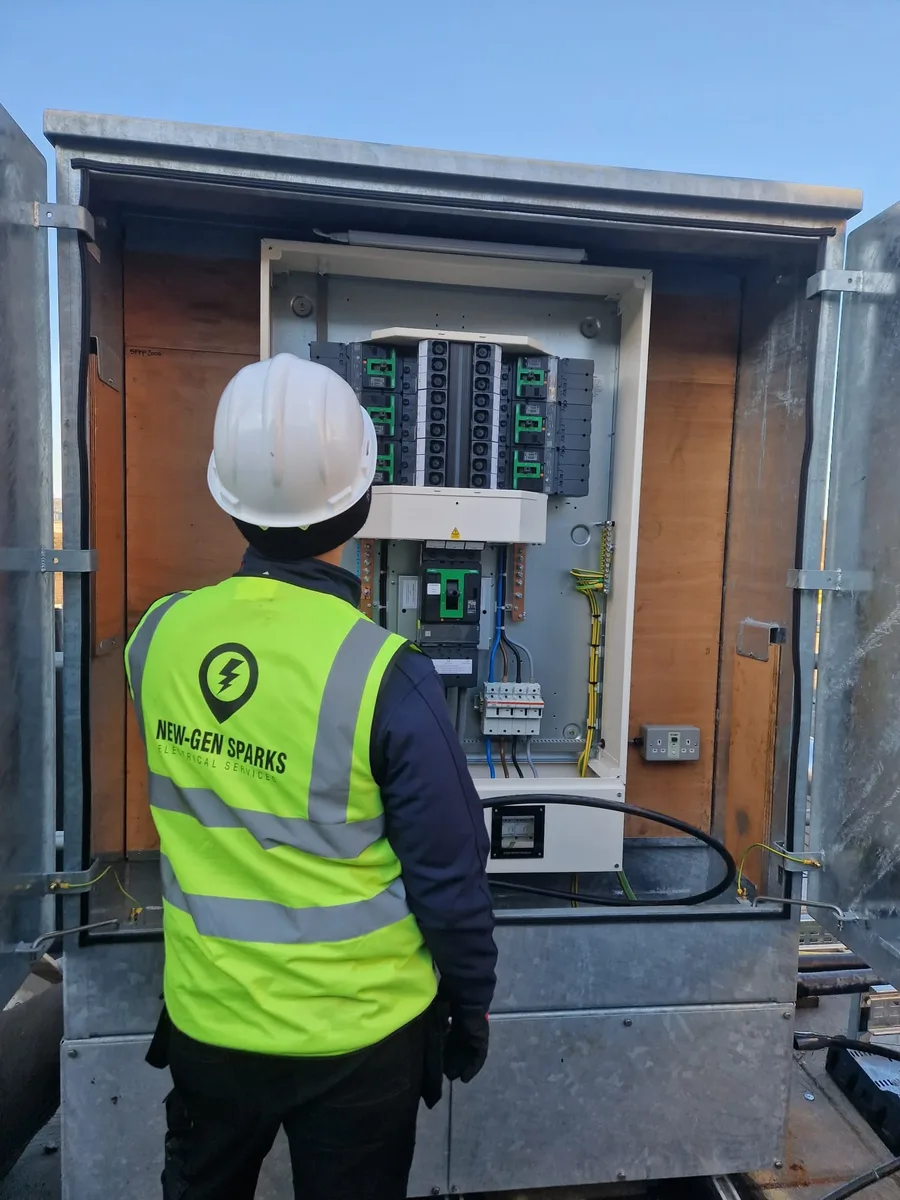 New-Gen Sparks engineer inspecting a commercial distribution board