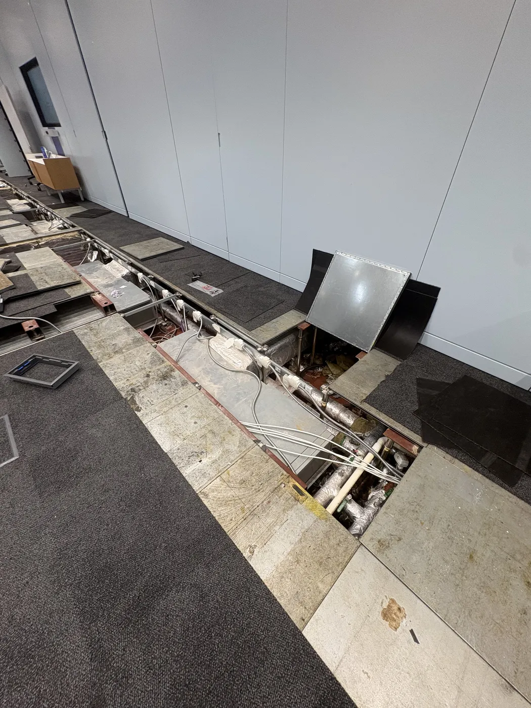 Raised-floor cabling and containment during an office fit-out in Hammersmith
