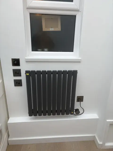 Wall-mounted electric radiator wired to a new fused spur in W2