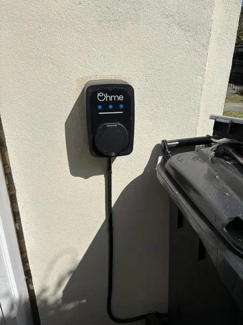 Ohme home EV charger installed on an exterior wall in Chiswick