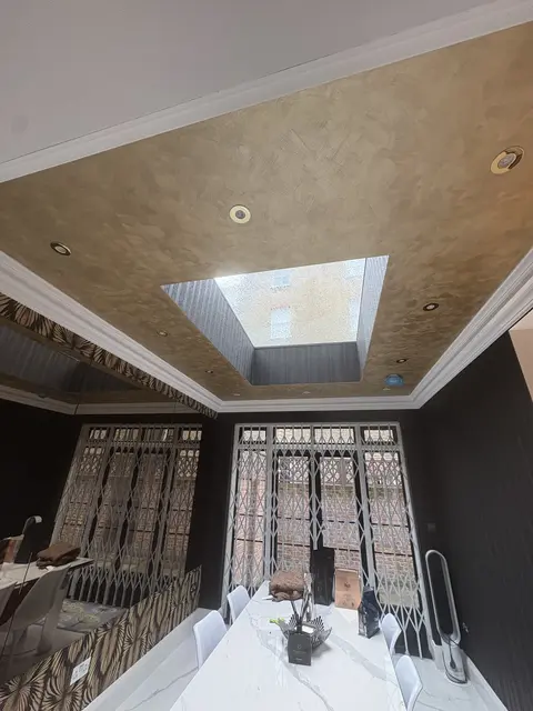 Recessed downlights in a gold feature ceiling with skylight in Hammersmith