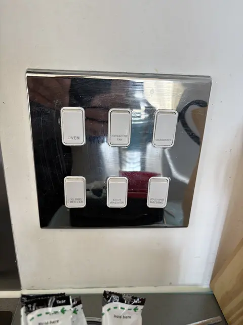 Engraved chrome six-gang grid switch for kitchen appliances in Kensington