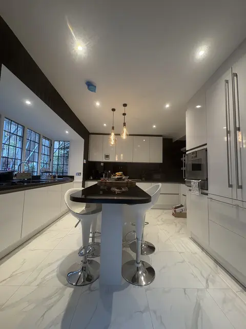 Finished kitchen in Hammersmith with recessed downlights and filament island pendants